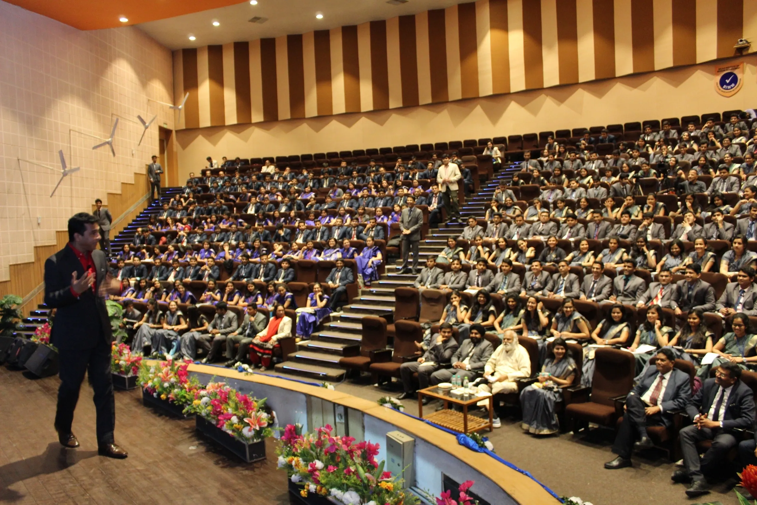 Dr. Pramod speaking to a large audience
